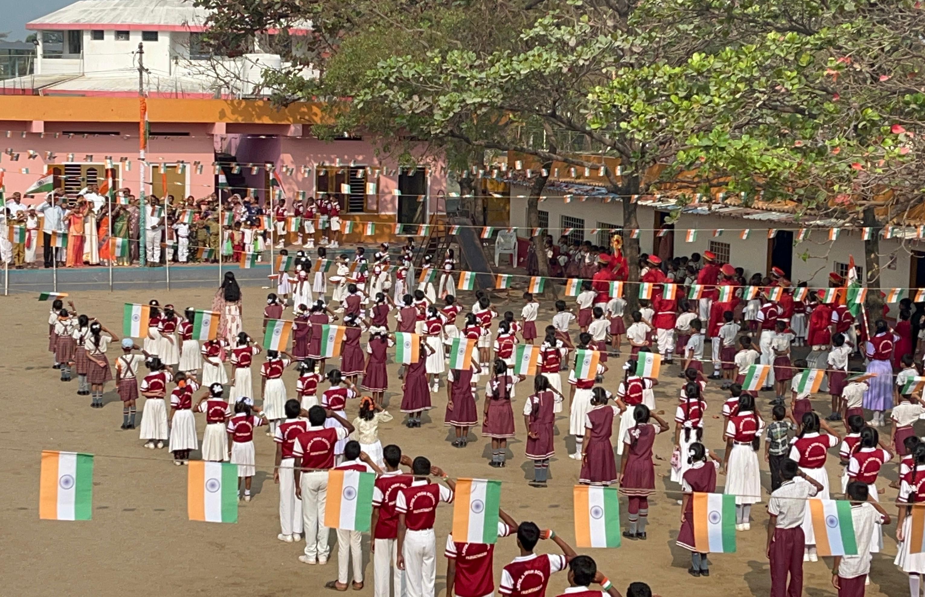 A campus assembly with students gathered in the school grounds